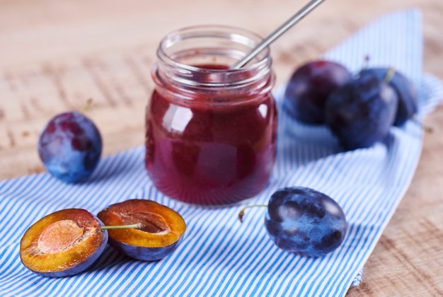 homemade-jar-plum-jam-with-spoon_329181-17744